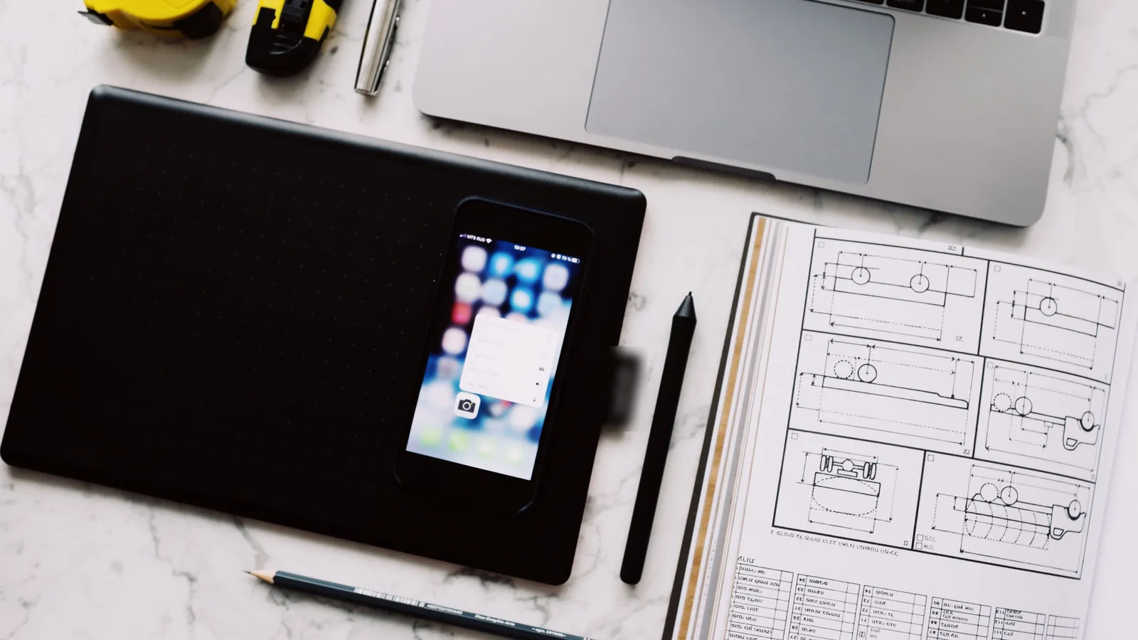 Laptop, tablet, and smartphone connected in a modern workplace.
